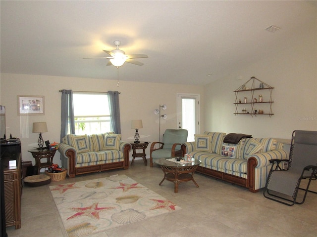 living room with ceiling fan and light tile patterned floors