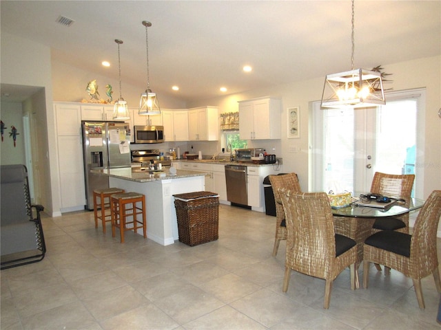 dining room featuring sink and vaulted ceiling