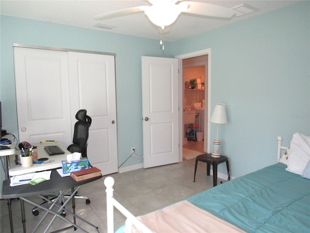 tiled bedroom with ceiling fan and a closet