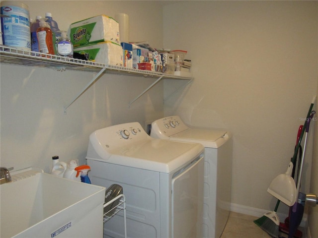 clothes washing area with washer and dryer and sink