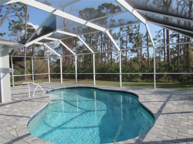 view of pool featuring a patio and glass enclosure