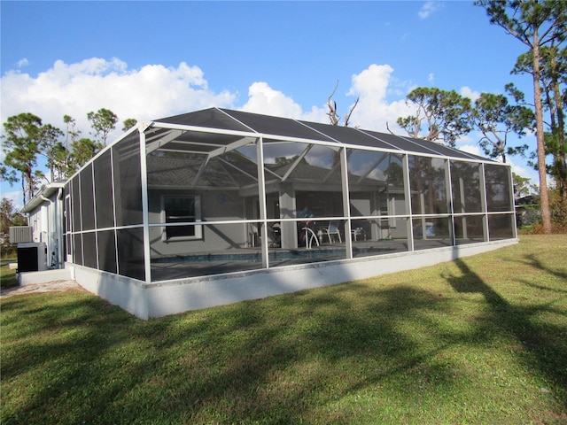 back of property featuring a yard and a lanai