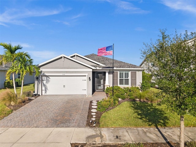 single story home with a garage and a front lawn