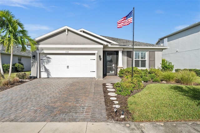 ranch-style house featuring a garage and a front yard