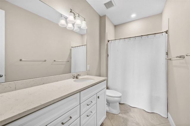 bathroom with tile patterned floors, vanity, and toilet