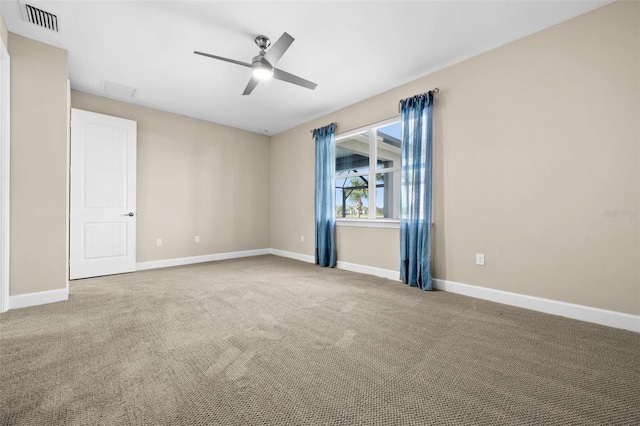 carpeted spare room with ceiling fan