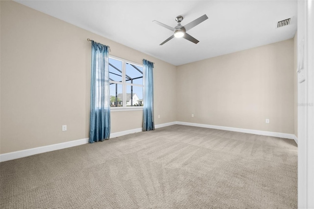 spare room with light carpet and ceiling fan