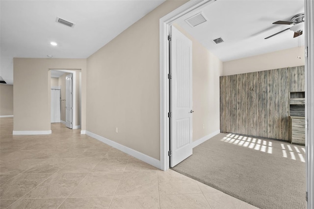 hallway with light colored carpet