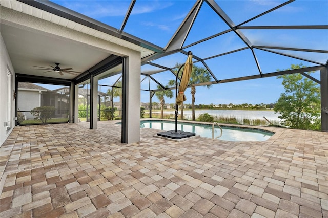 view of pool with a patio area, a water view, a lanai, and ceiling fan