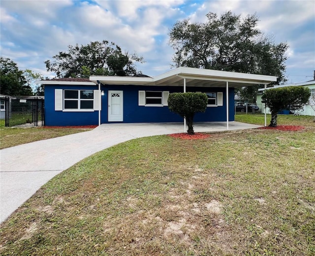 view of front of house with a carport and a front lawn