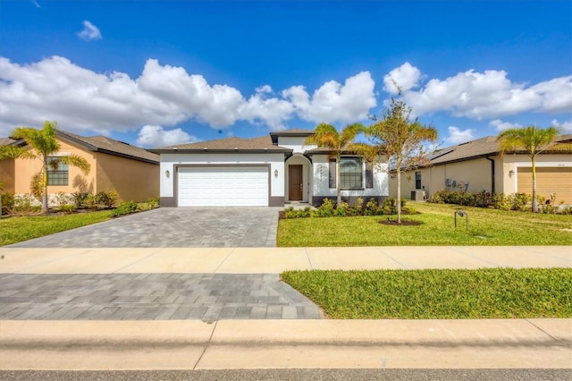 view of front of home featuring a front lawn and a garage