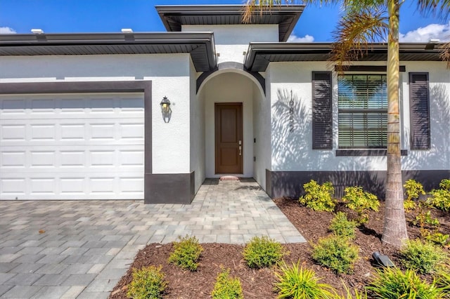 doorway to property with a garage