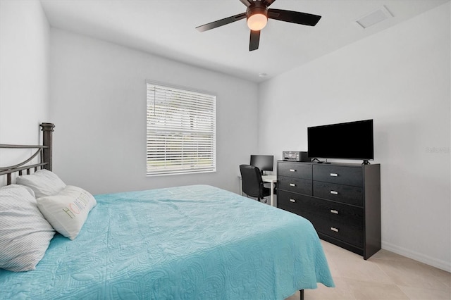 tiled bedroom featuring ceiling fan