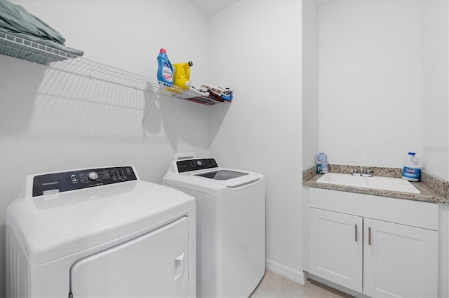 washroom featuring cabinets, washer and dryer, and sink