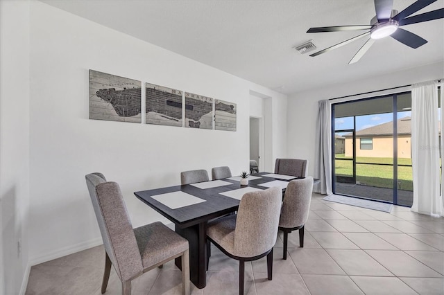 tiled dining space with ceiling fan