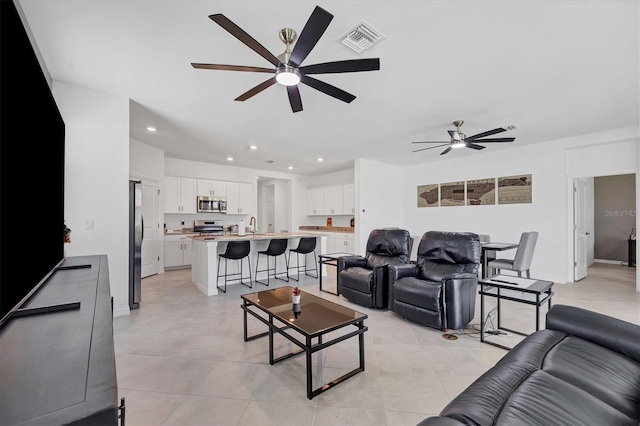 tiled living room featuring ceiling fan