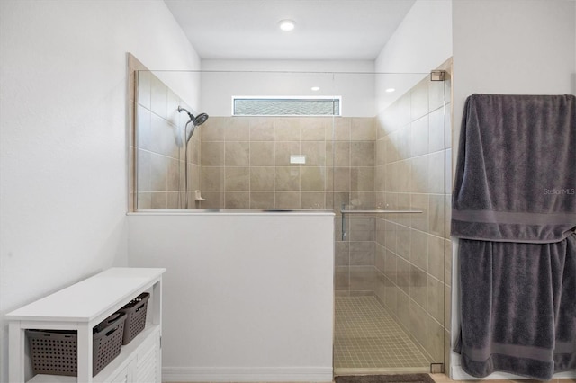 bathroom with a shower with door