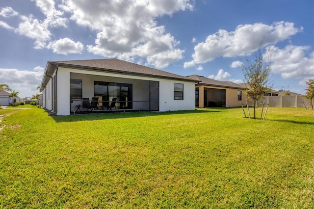 rear view of house featuring a yard