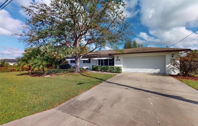 ranch-style house featuring a garage and a front lawn