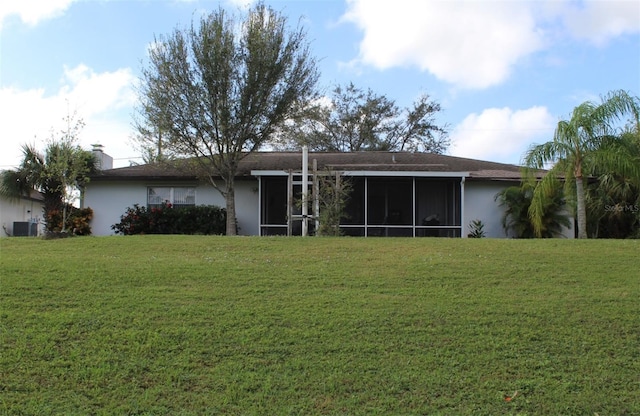 back of property featuring a yard, central air condition unit, and a sunroom