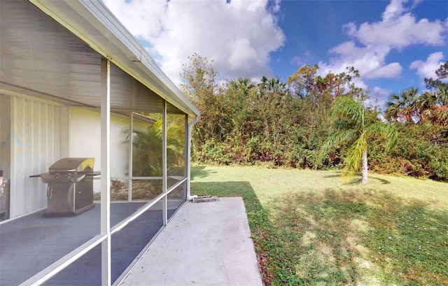 view of yard featuring a patio area and a sunroom