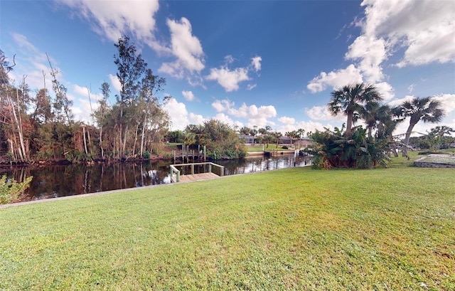 view of yard featuring a water view and a dock