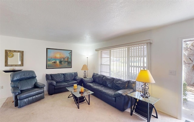 living room with a wealth of natural light, carpet floors, and a textured ceiling