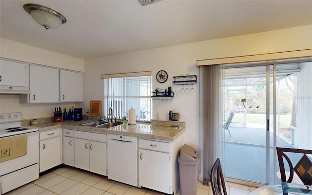 kitchen featuring white cabinets, white appliances, sink, and light tile patterned floors