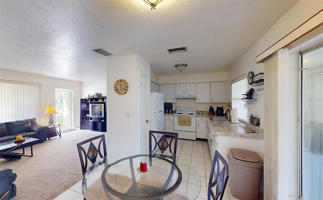 kitchen with white cabinetry, sink, white appliances, and a textured ceiling