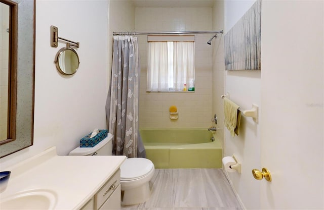 full bathroom with vanity, shower / bath combo, and toilet