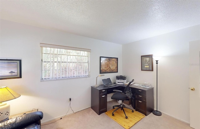 home office featuring light colored carpet and a textured ceiling