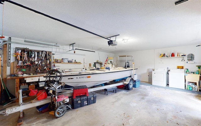 garage with a workshop area, separate washer and dryer, and a garage door opener