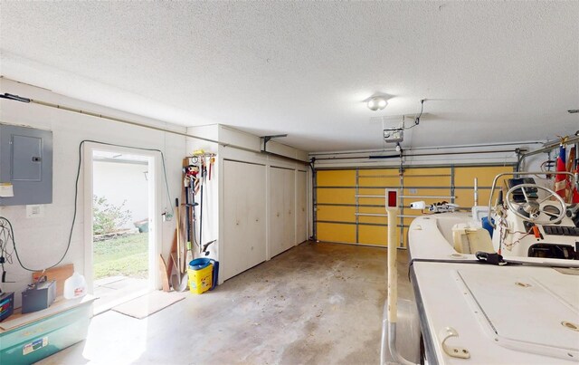 garage featuring electric panel and a garage door opener