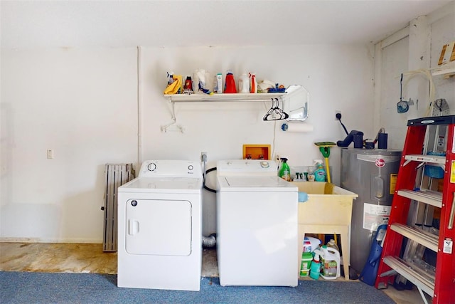 washroom with carpet flooring, washing machine and dryer, and electric water heater