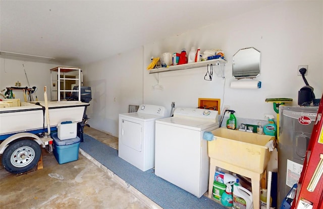 laundry room featuring washer and dryer, sink, and water heater