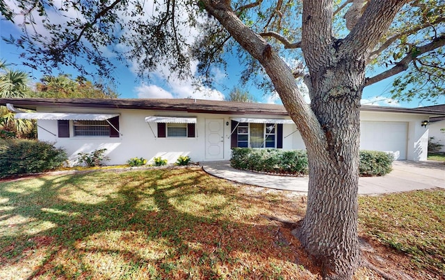 single story home with a front yard and a garage