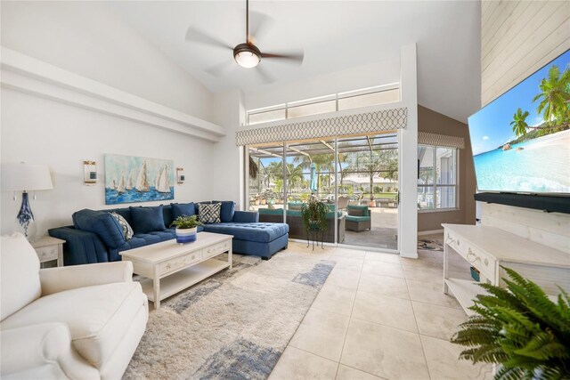 living room featuring high vaulted ceiling, light tile patterned floors, and ceiling fan