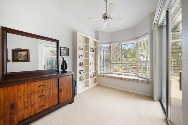 interior space featuring light colored carpet and ceiling fan