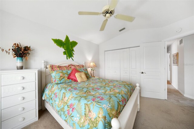 carpeted bedroom featuring ceiling fan, a closet, and lofted ceiling