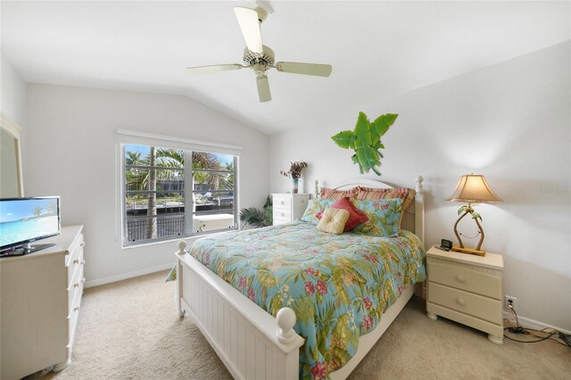 carpeted bedroom with ceiling fan and vaulted ceiling