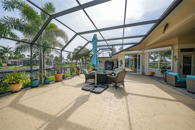 view of patio / terrace featuring outdoor lounge area and glass enclosure