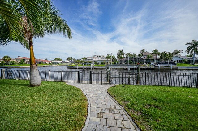 exterior space with a water view and a lawn