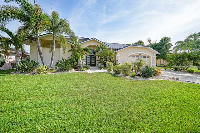 view of front of property featuring a garage and a front yard