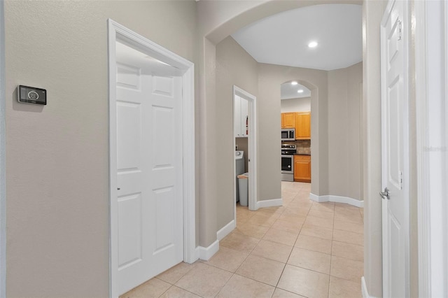 hall with light tile patterned floors