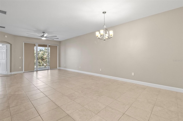 tiled spare room featuring ceiling fan with notable chandelier