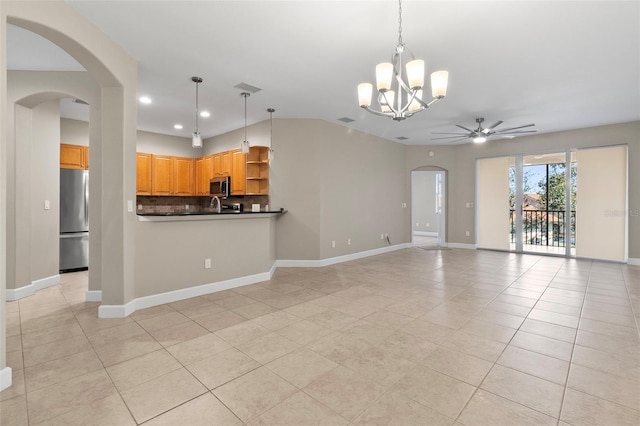 kitchen with ceiling fan with notable chandelier, appliances with stainless steel finishes, light tile patterned floors, and backsplash