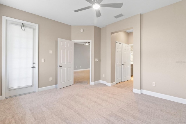 unfurnished bedroom with light colored carpet and ceiling fan