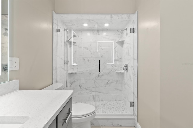 bathroom with walk in shower, vanity, and toilet