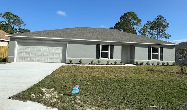 ranch-style house featuring a garage and a front yard