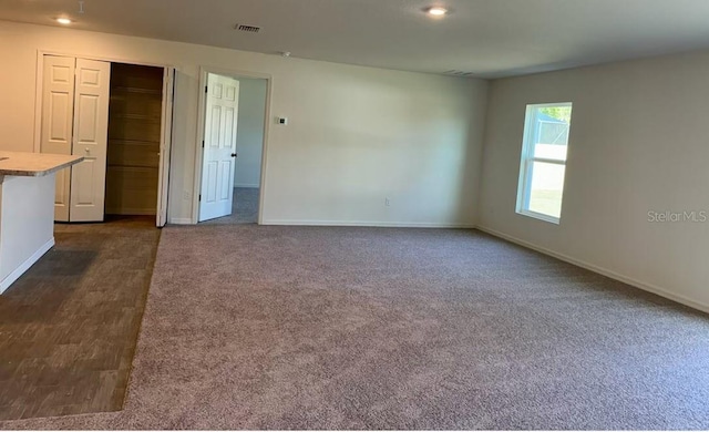 unfurnished room with dark hardwood / wood-style flooring